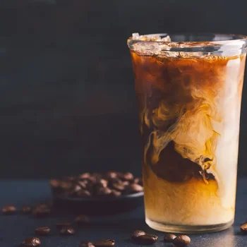 Iced coffee with cream in tall glass